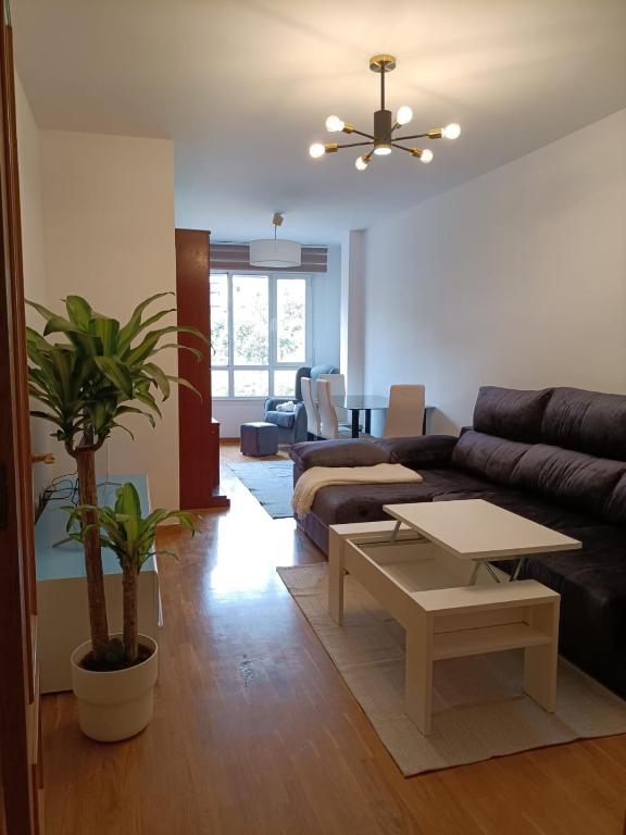 a living room with a couch and a table at Apt. Descenso del Sella, Arriondas in Arriondas
