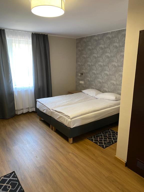 Posteľ alebo postele v izbe v ubytovaní GRACJA