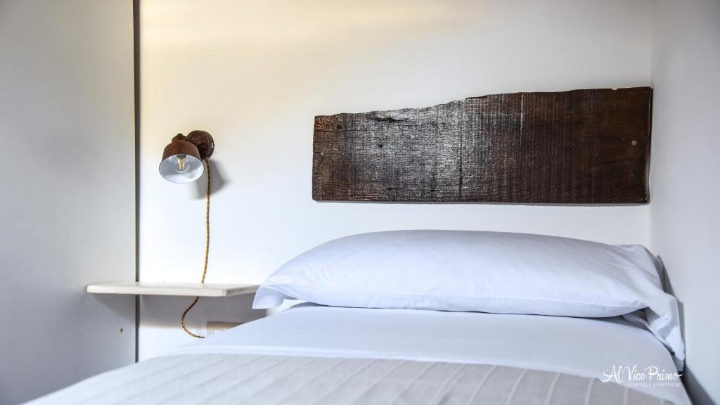 A bed or beds in a room at Al Vico Primo - Boutique Apartment