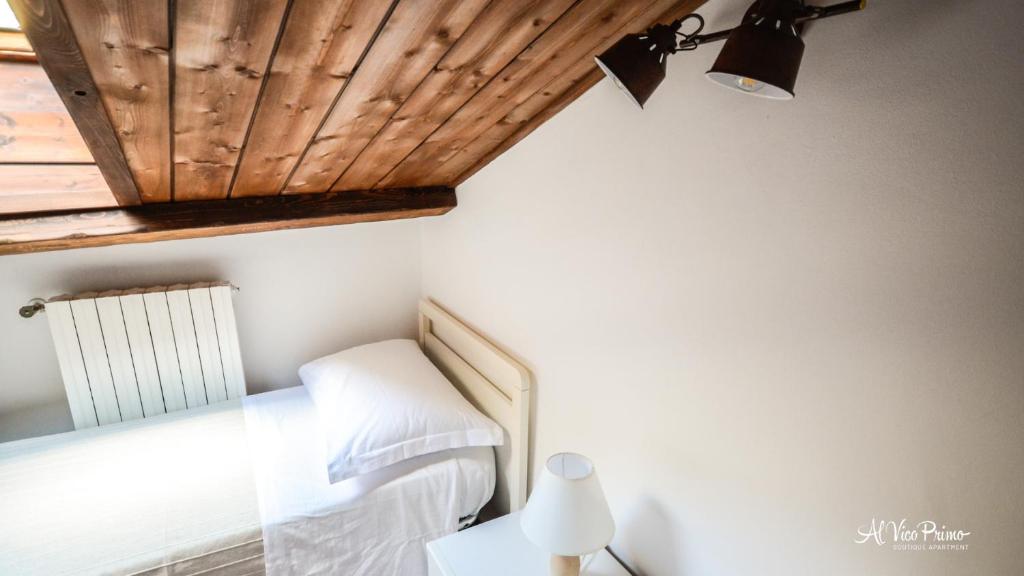 A bed or beds in a room at Al Vico Primo - Boutique Apartment