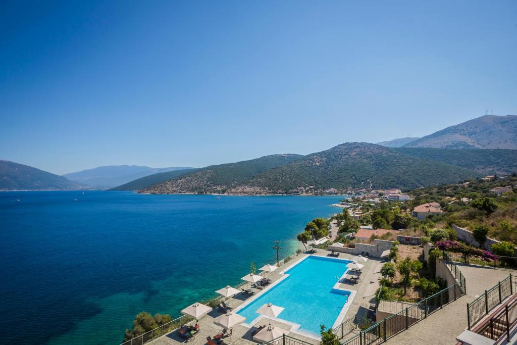 an aerial view of a lake with a swimming pool at Kefalonia Bay Palace in Kefallonia