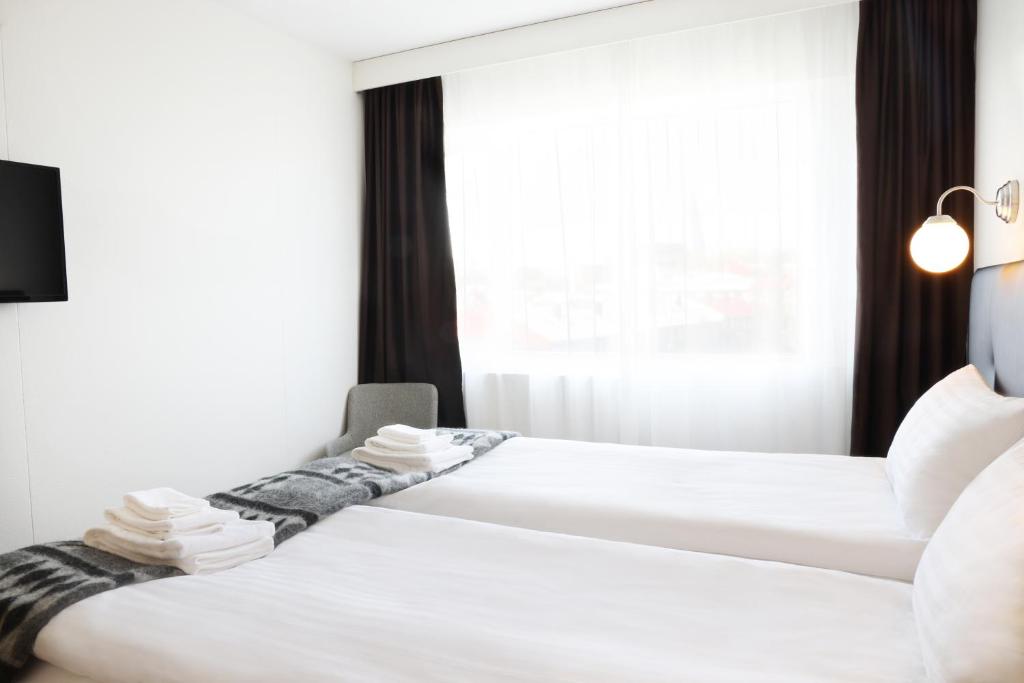 Postel nebo postele na pokoji v ubytování Fosshotel Lind