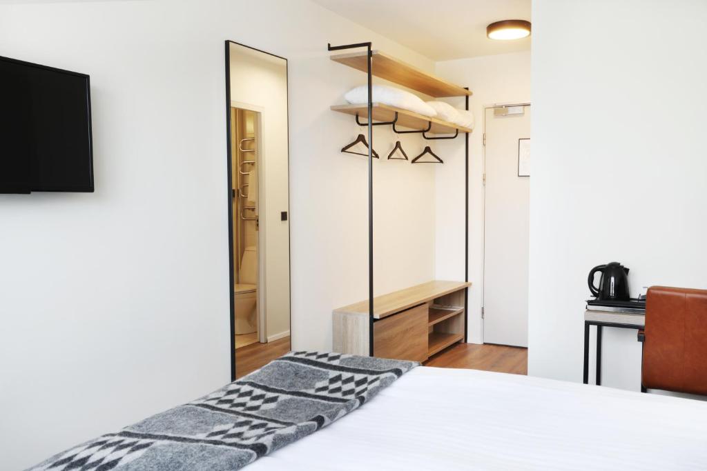 Postel nebo postele na pokoji v ubytování Fosshotel Lind