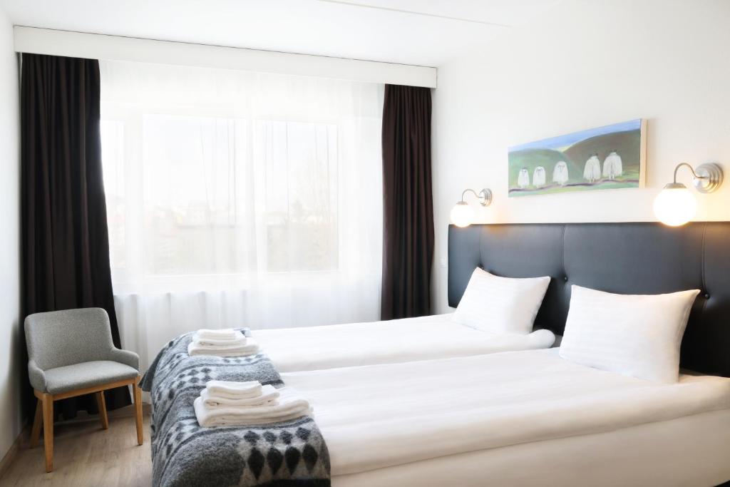 Postel nebo postele na pokoji v ubytování Fosshotel Lind
