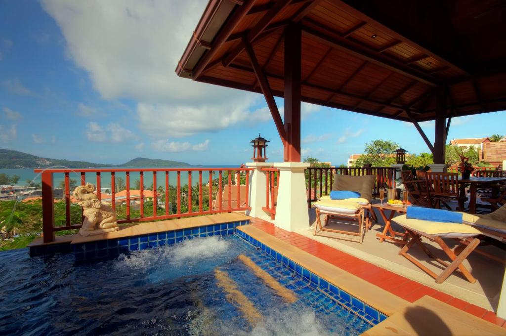 a pool on a house with a view of the water at Patong Seaview Luxury Villa Penda in Patong Beach