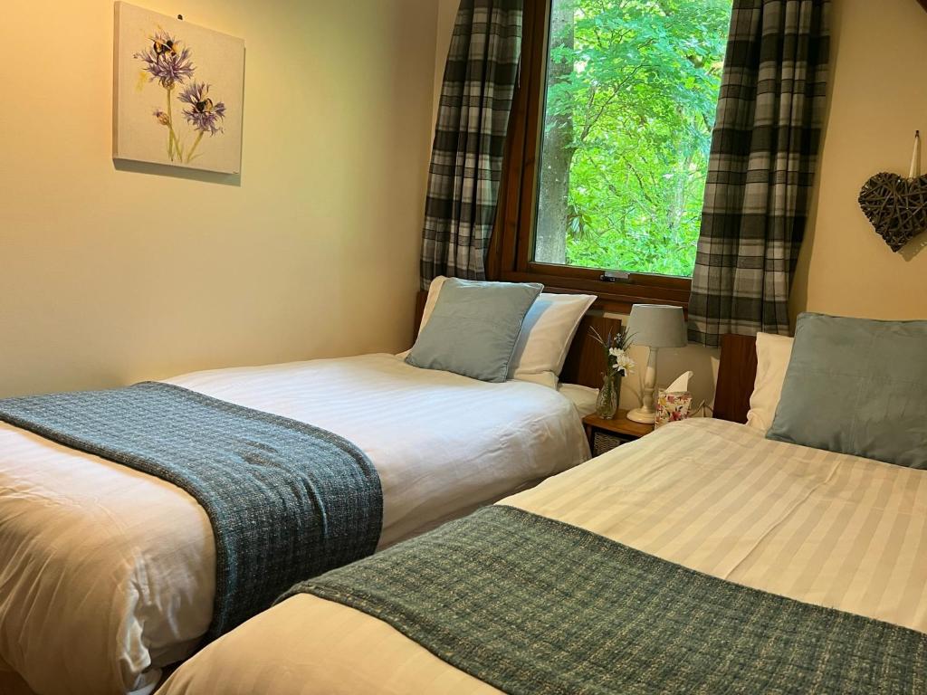 Postel nebo postele na pokoji v ubytování Ericht Holiday Lodges