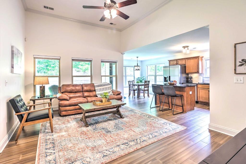 a living room with a couch and a table at Family Friendly Calera Getaway with Game Room! in Calera