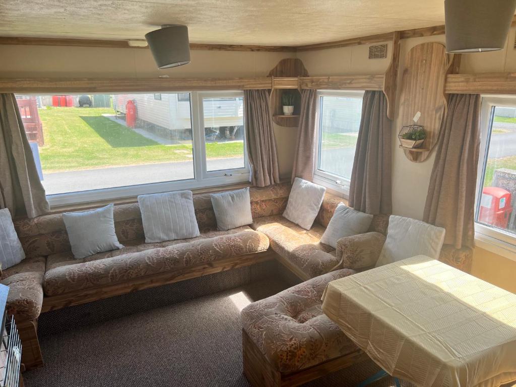 a living room with a couch and a table at Castaway retreats 4 C34 in Lincolnshire