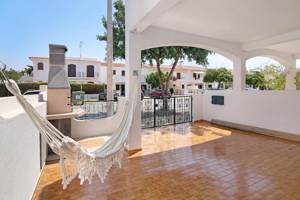 a hammock on the balcony of a house at Altura Beach Villa in Altura