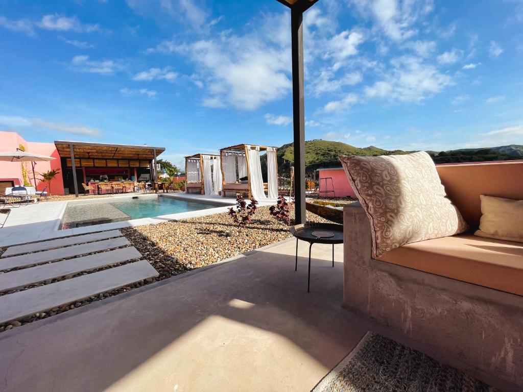 a patio with a couch and a swimming pool at Casa De Amigos Hotel Boutique in Honda