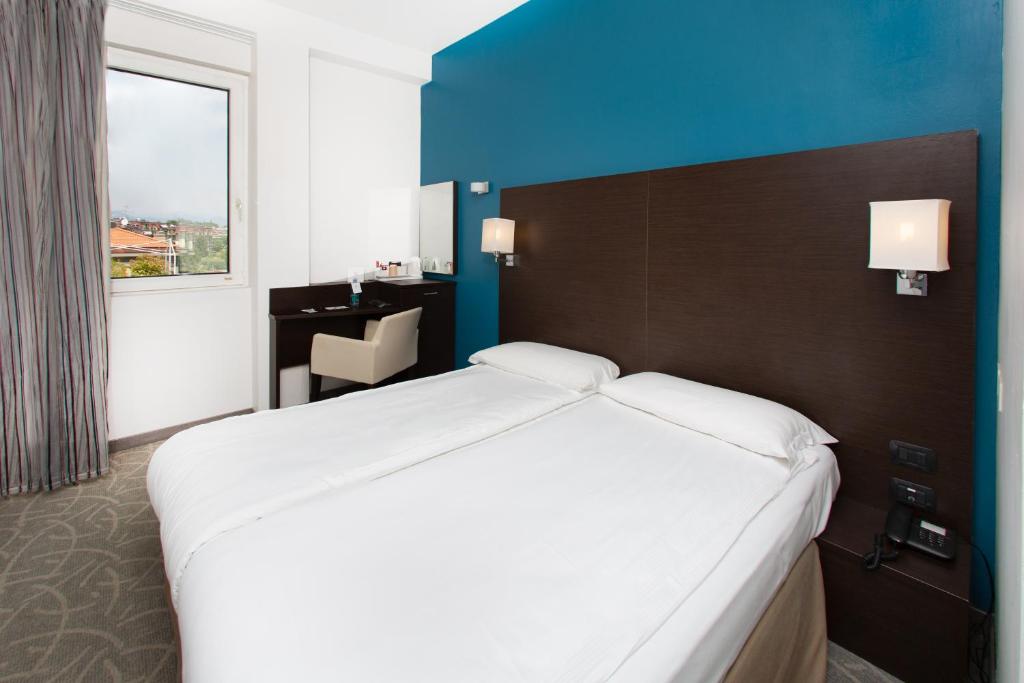 Postel nebo postele na pokoji v ubytování Hotel Bonotto