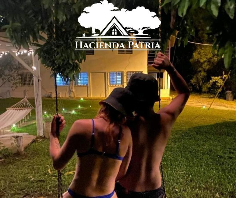 a woman in a bikini standing in front of a house at Hacienda Patria 