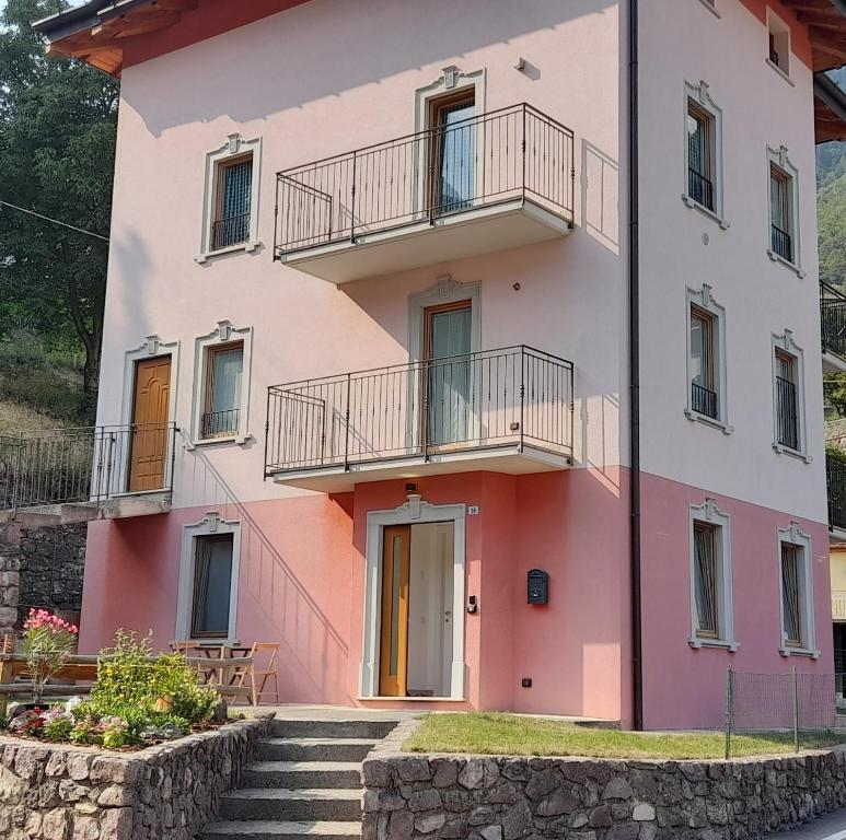 a pink house with stairs in front of it at Villa Geltrude in Cusio
