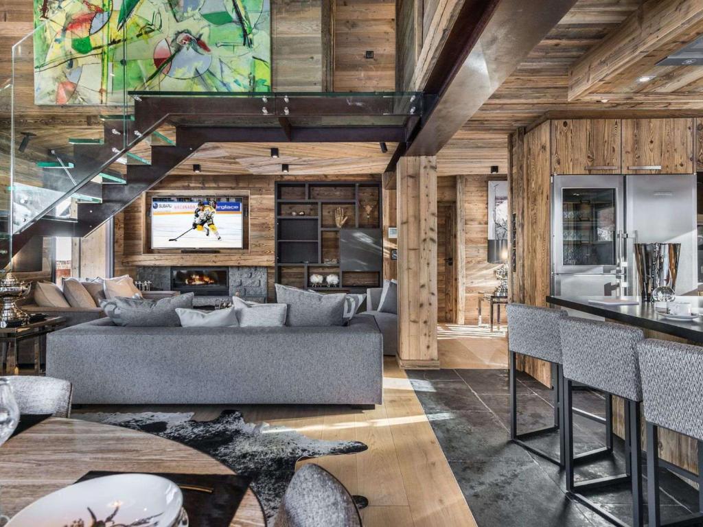 a living room with a couch and a tv at Chalet Megève, 7 pièces, 12 personnes - FR-1-569-10 in Megève