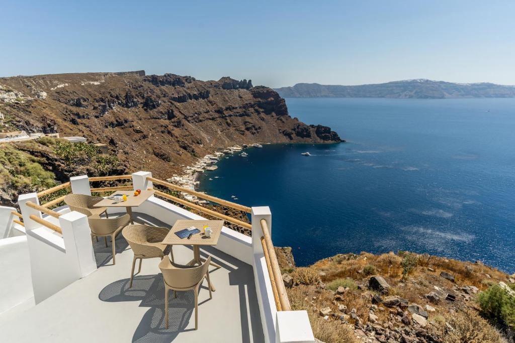 a balcony with chairs and a view of the ocean at Evanthia Best View Thirassia Island Hotel in Therasia
