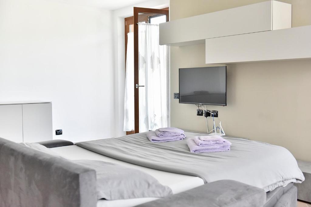 Łóżko lub łóżka w pokoju w obiekcie La Pieve Apartments