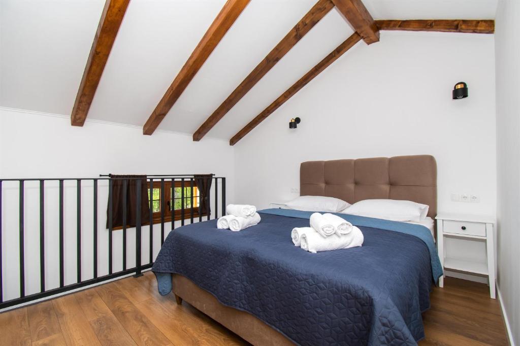a bedroom with a bed with towels on it at Villa Lucia in Skradin