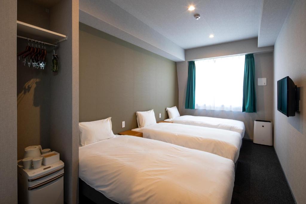מיטה או מיטות בחדר ב-IMANO OSAKA SHINSAIBASHI HOSTEL - Vacation STAY 03958v