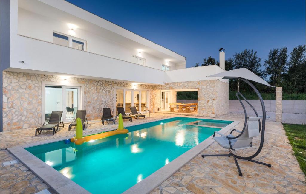 a swimming pool in the backyard of a house at 4 Bedroom Beautiful Home In Jursici in Juršići