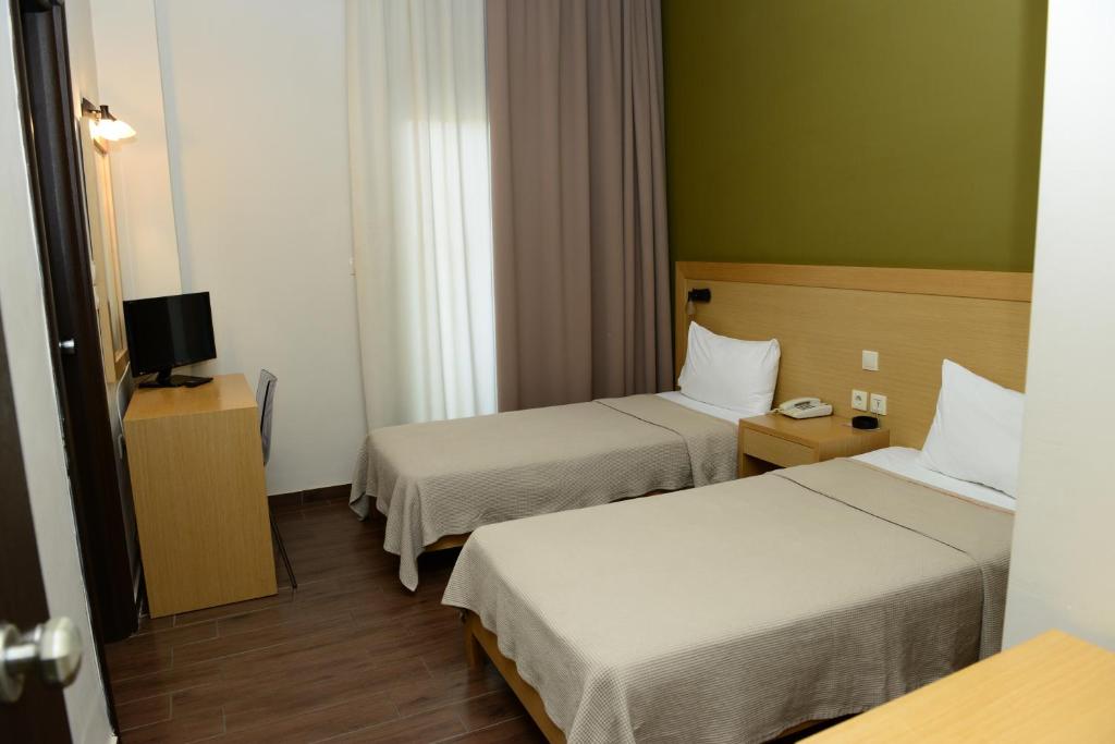 Postel nebo postele na pokoji v ubytování Ionion Hotel