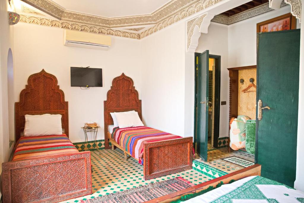 Postel nebo postele na pokoji v ubytování Riad Ouliya