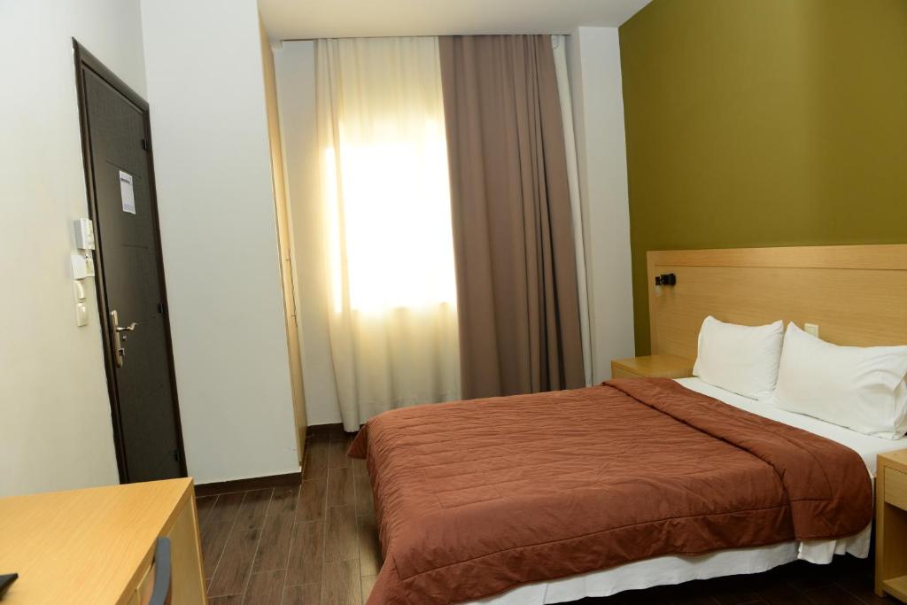 Postel nebo postele na pokoji v ubytování Ionion Hotel