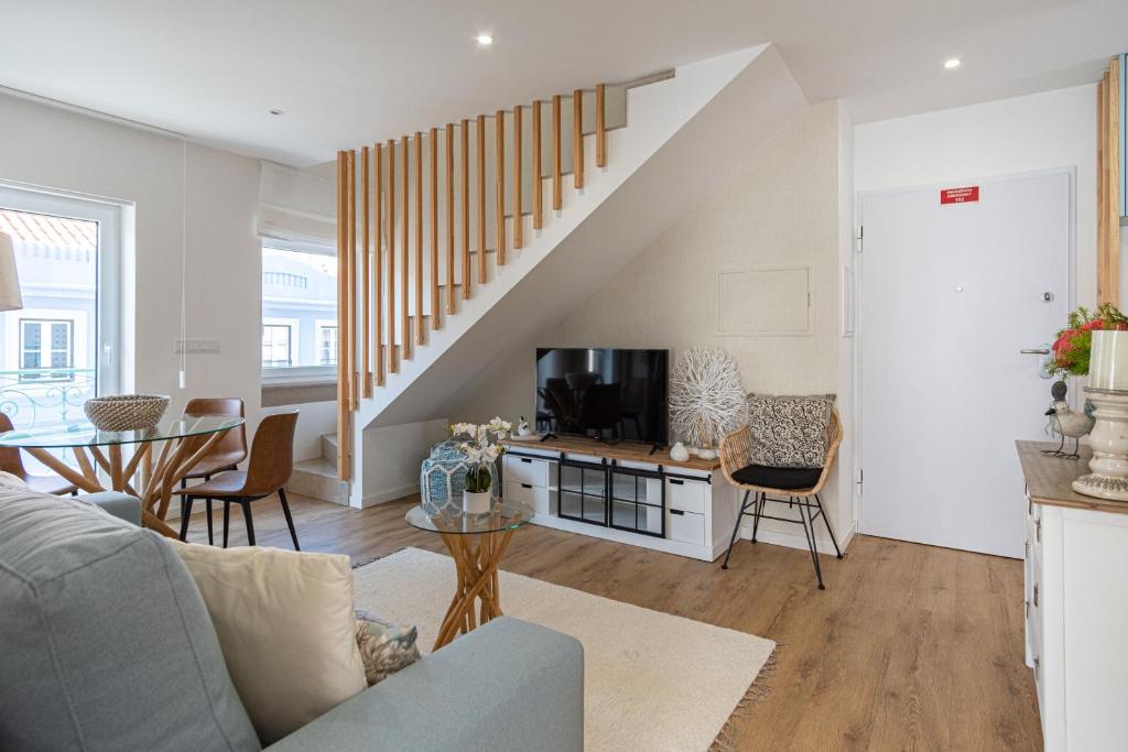 a living room with a couch and a tv at Feel Nazare - Saudade 57 in Nazaré