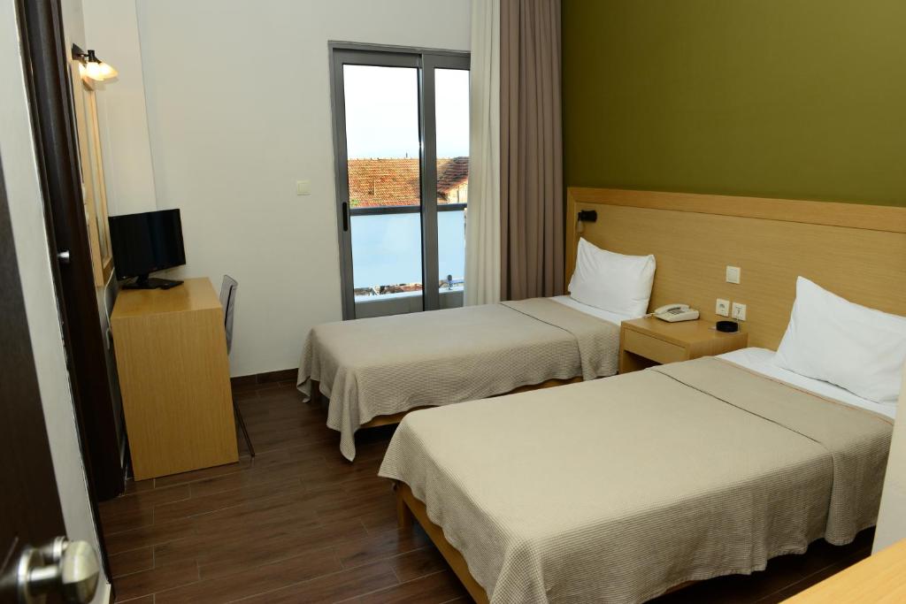 Postel nebo postele na pokoji v ubytování Ionion Hotel