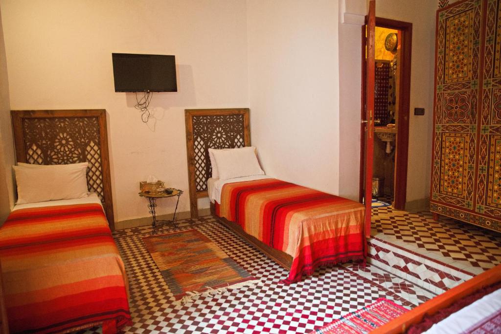 Postel nebo postele na pokoji v ubytování Riad Ouliya