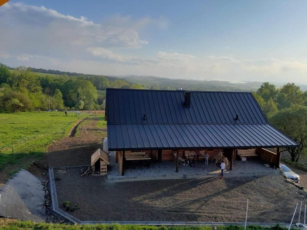 an overhead view of a house with a blue roof at Kuźnia Nowica in Uście Gorlickie