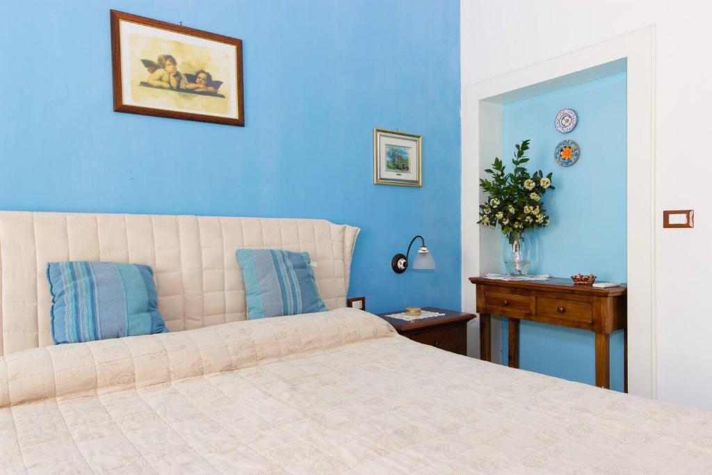 Postel nebo postele na pokoji v ubytování L'Isola Di Ortigia