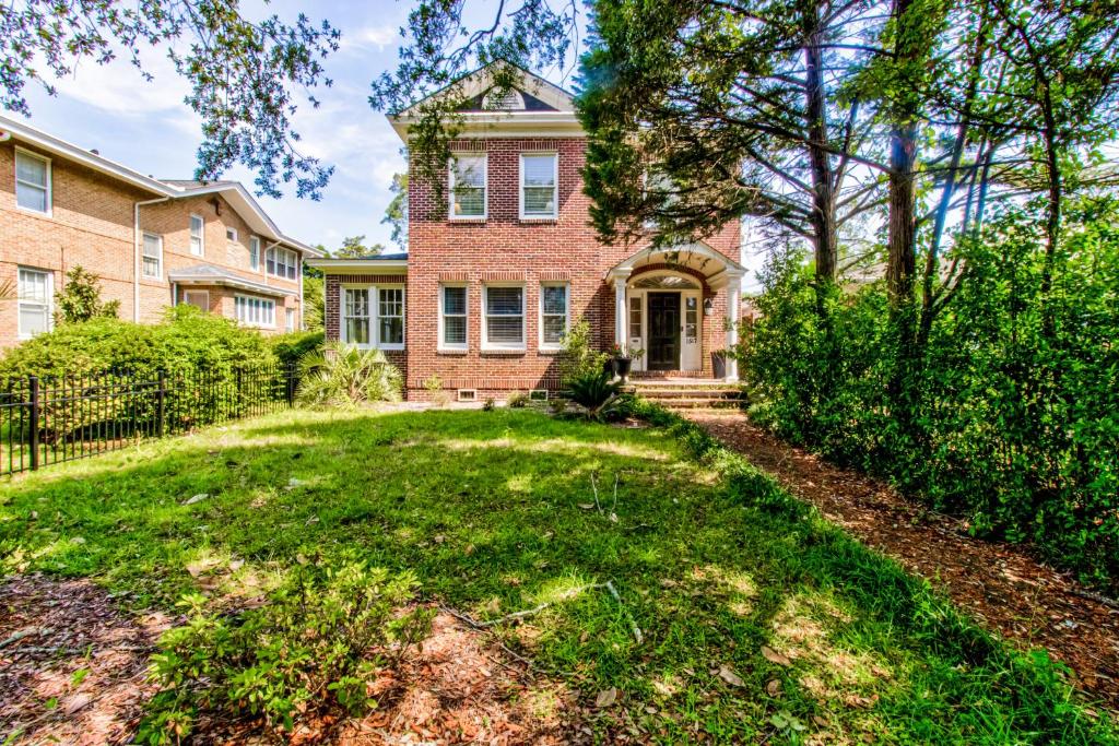 a brick house with a yard in front of it at Historic Charmer in Wilmington