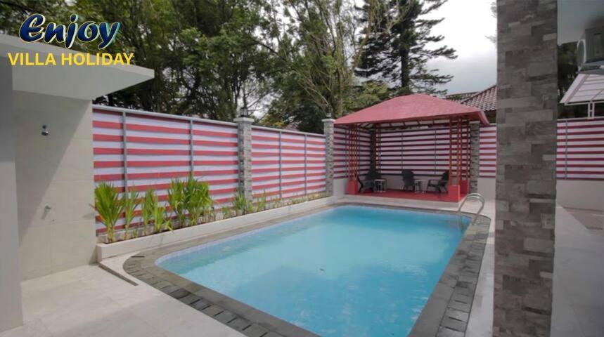 a swimming pool in a backyard with a gazebo at Alulu Luxury Residence - Four Bedroom Villa in Cikundul