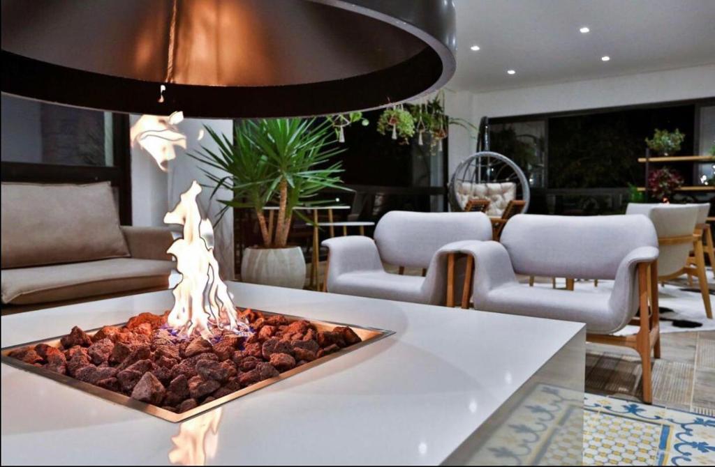 a fireplace in the middle of a living room at Carpe Diem Spa & boutique in Campos do Jordão