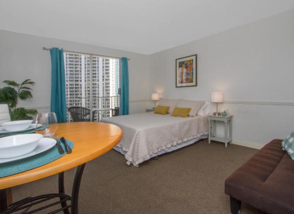 a bedroom with a bed and a table with a dining room at Vacation Apartment for Couples in Honolulu Hawaii in Honolulu