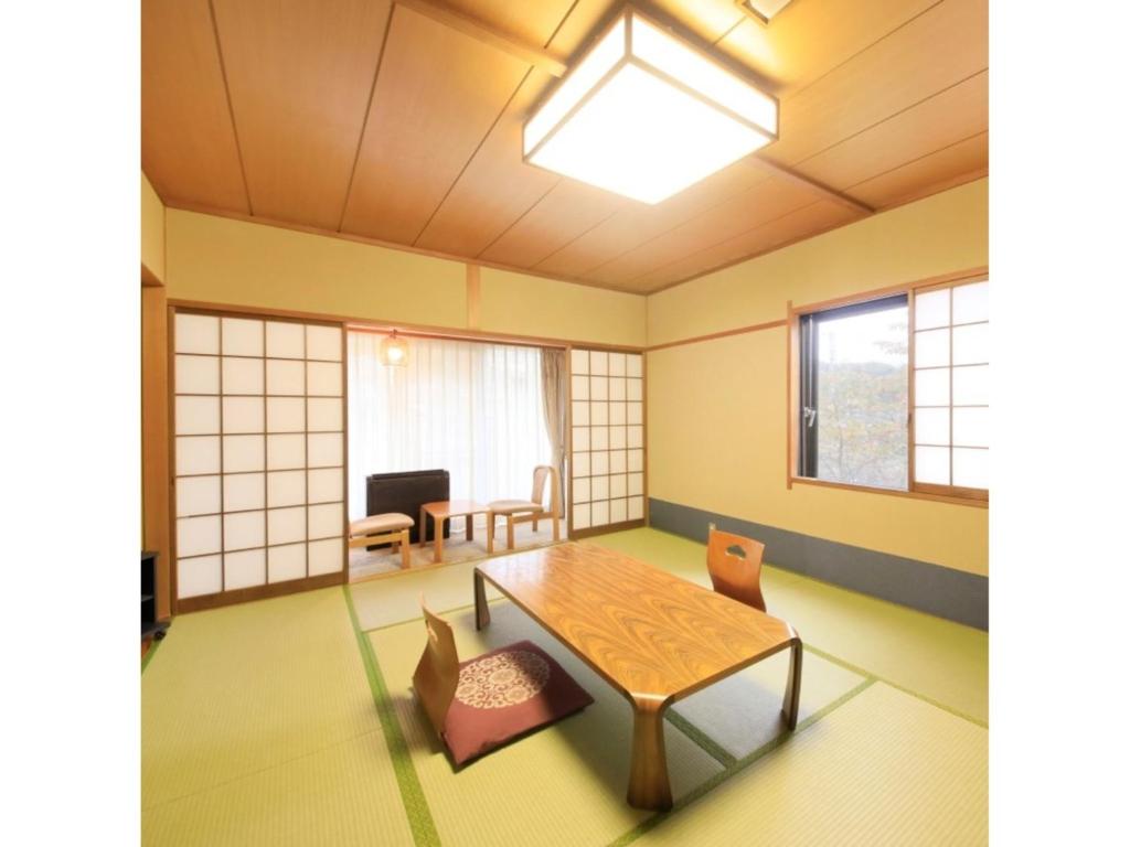 a living room with a table and chairs at Kasuga no mori - Vacation STAY 80247v in Saku