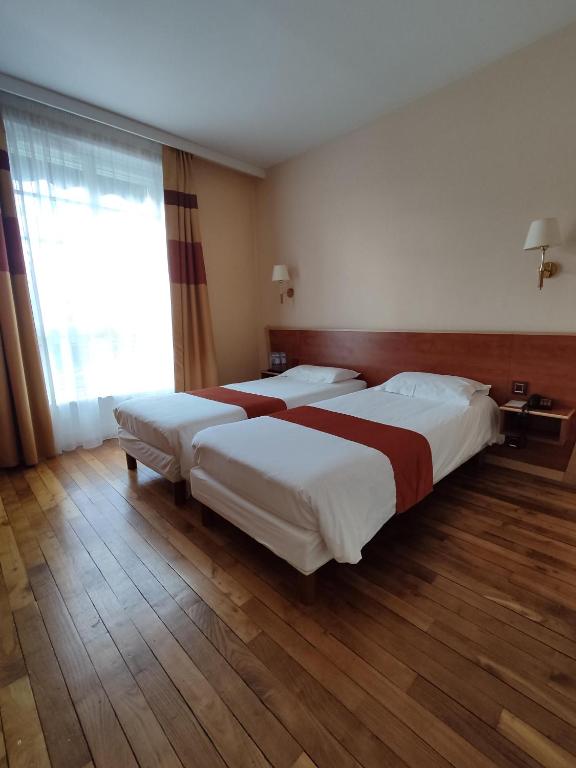 Postel nebo postele na pokoji v ubytování Hôtel Vauban