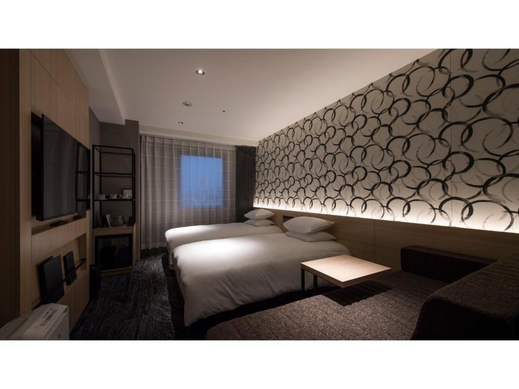 a hotel room with two beds and a wall at Tmark City Hotel Kanazawa - Vacation STAY 90395v in Kanazawa