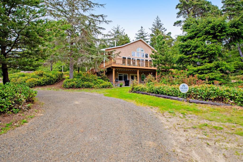 a home with a driveway leading to a house at Huckleberry Haven in Tillamook