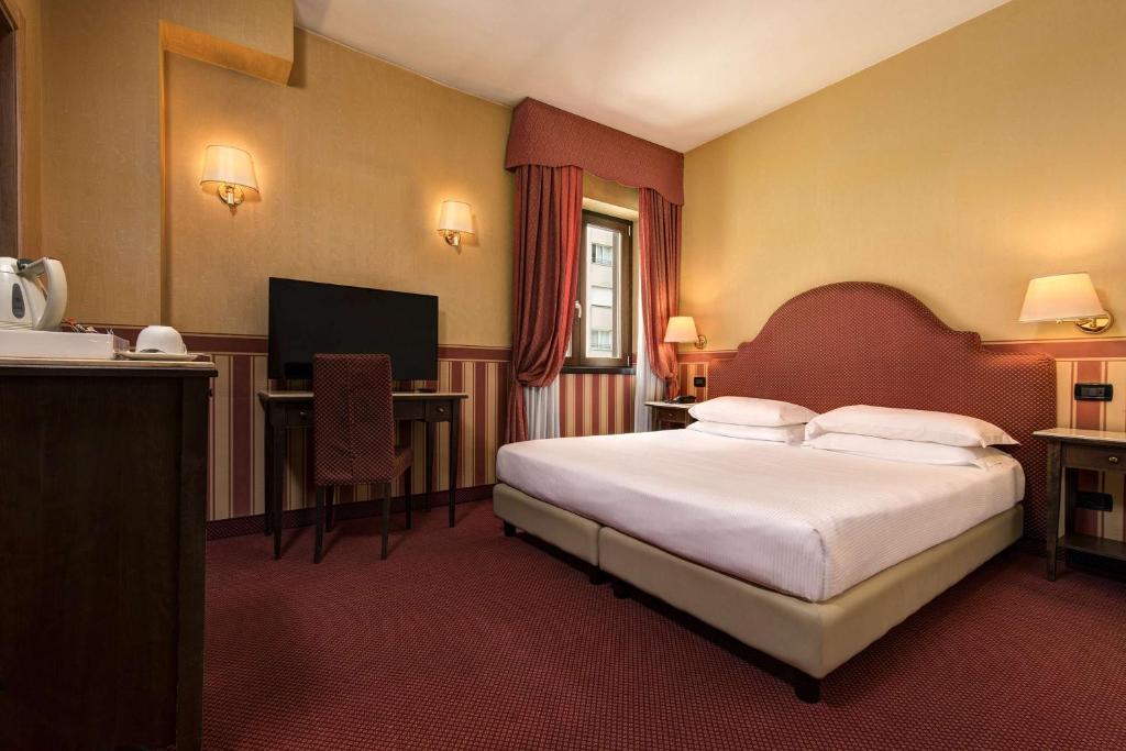 Postel nebo postele na pokoji v ubytování Best Western Hotel Tritone
