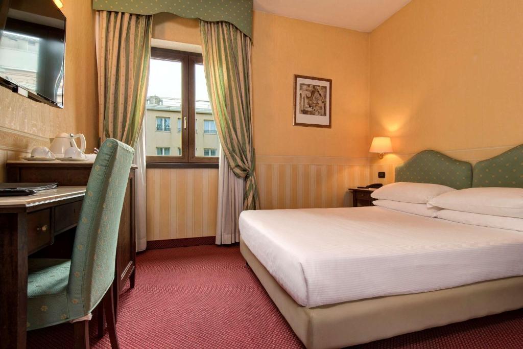 Postel nebo postele na pokoji v ubytování Best Western Hotel Tritone