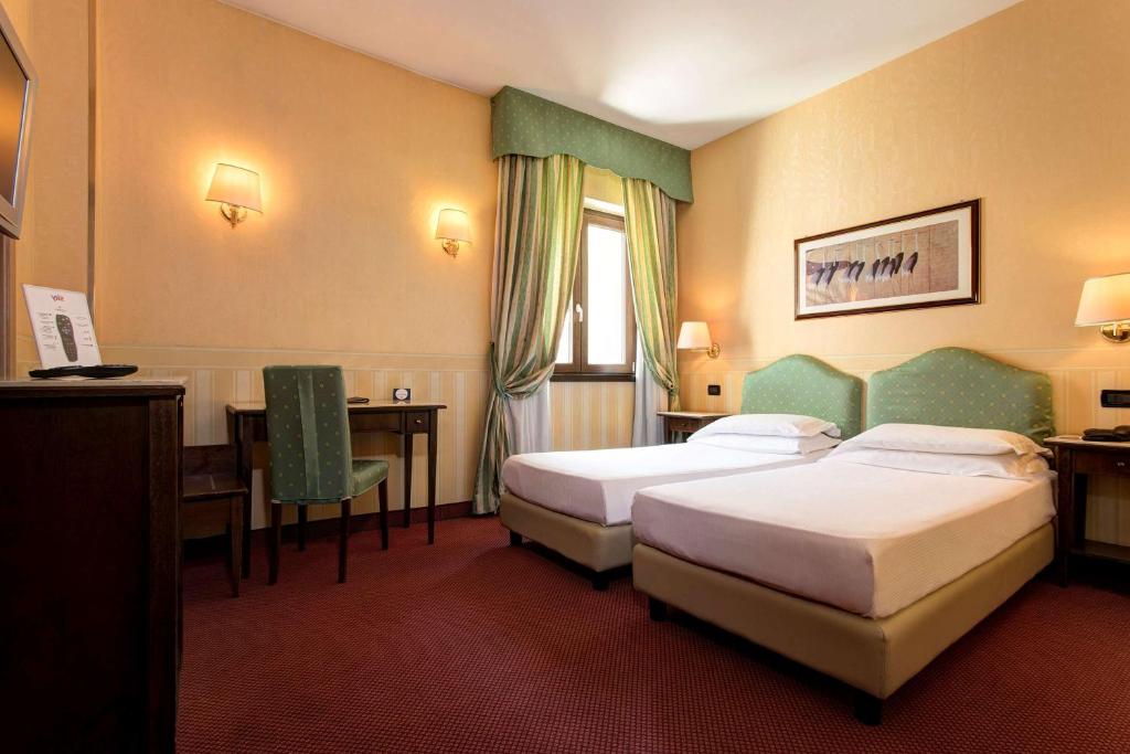 Postel nebo postele na pokoji v ubytování Best Western Hotel Tritone