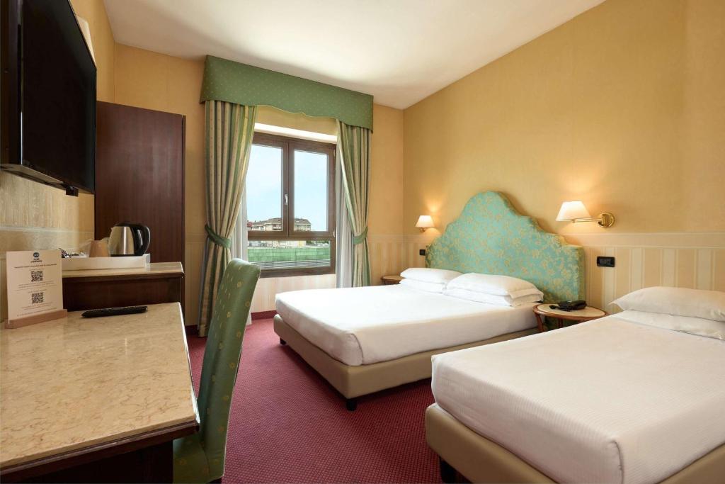 Postel nebo postele na pokoji v ubytování Best Western Hotel Tritone