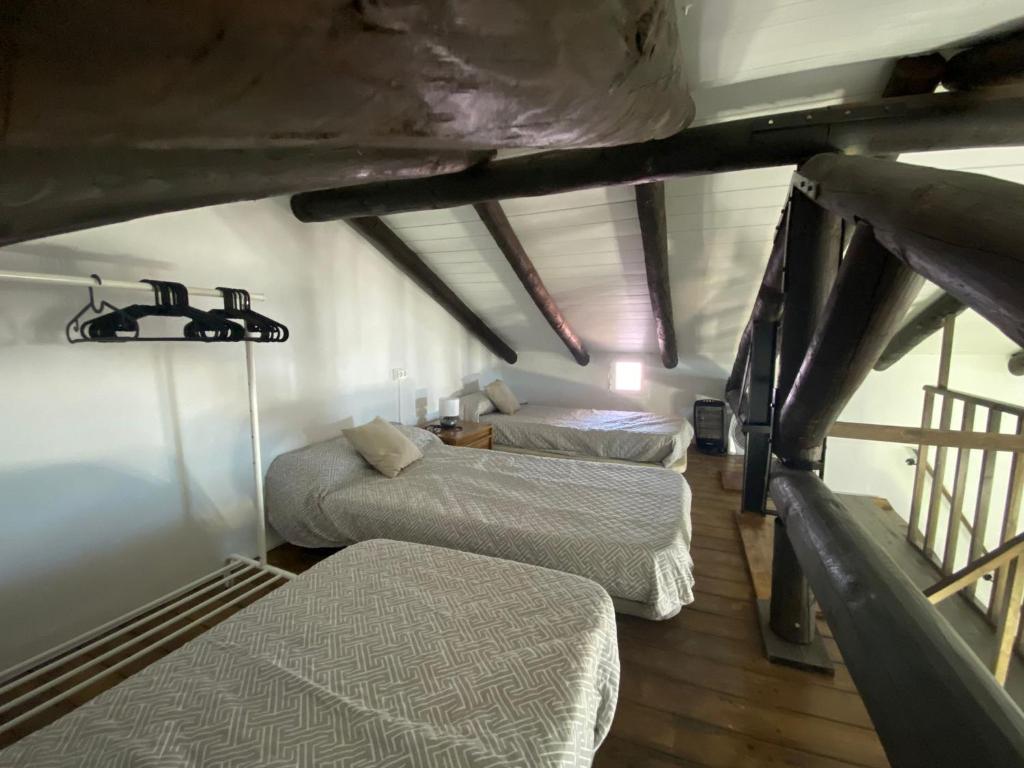 a bedroom with three beds in a room at Pequeño Rocío Urbanizacion privada in El Rocío