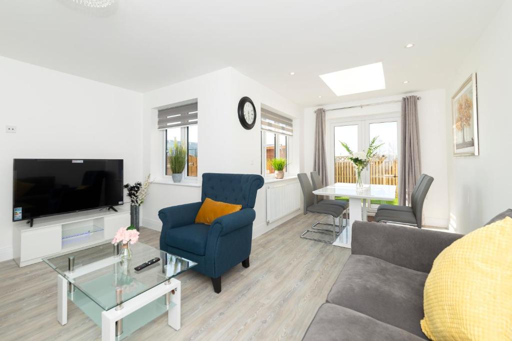 a living room with a couch and a tv at Greenfield Holiday Homes in Bracknell