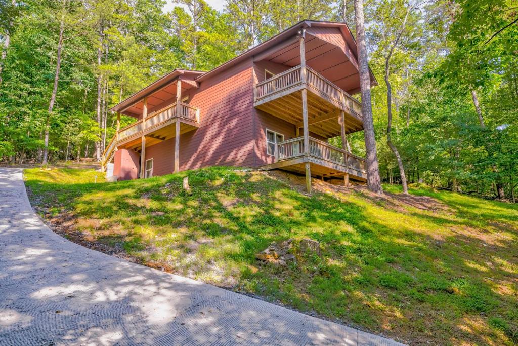 a house with two decks on a hill in the woods at Cozy Cabin in Ellijay