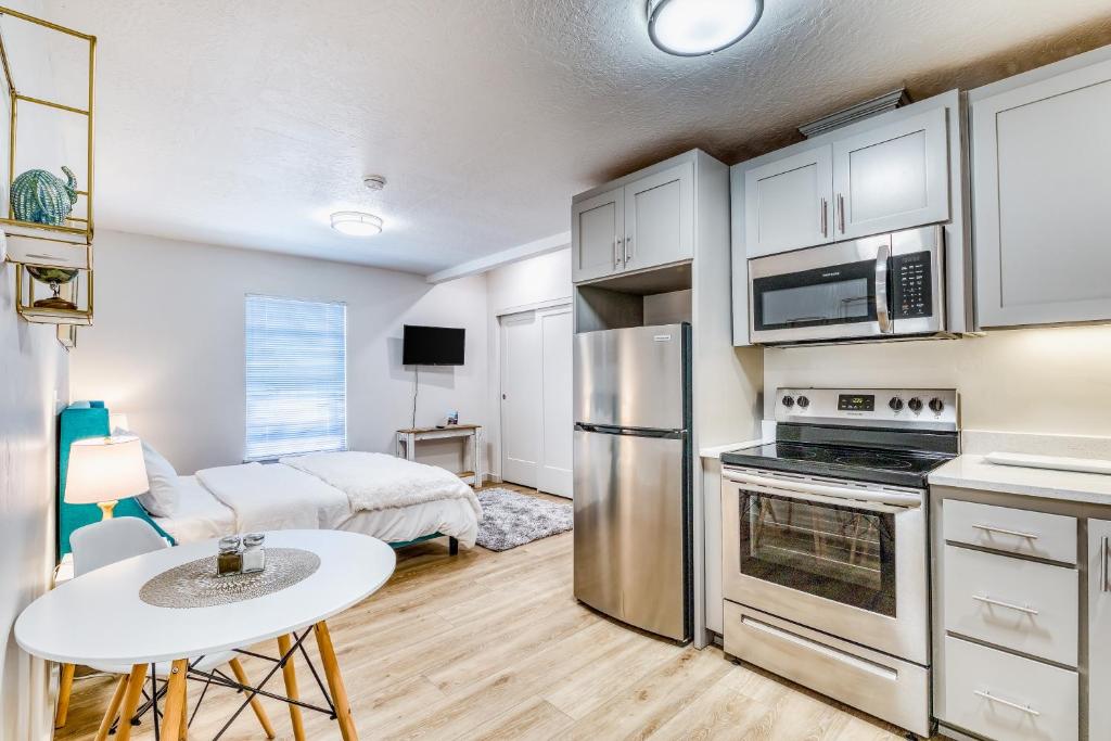 a kitchen with stainless steel appliances and a living room at Pearl Street Studio in Eugene