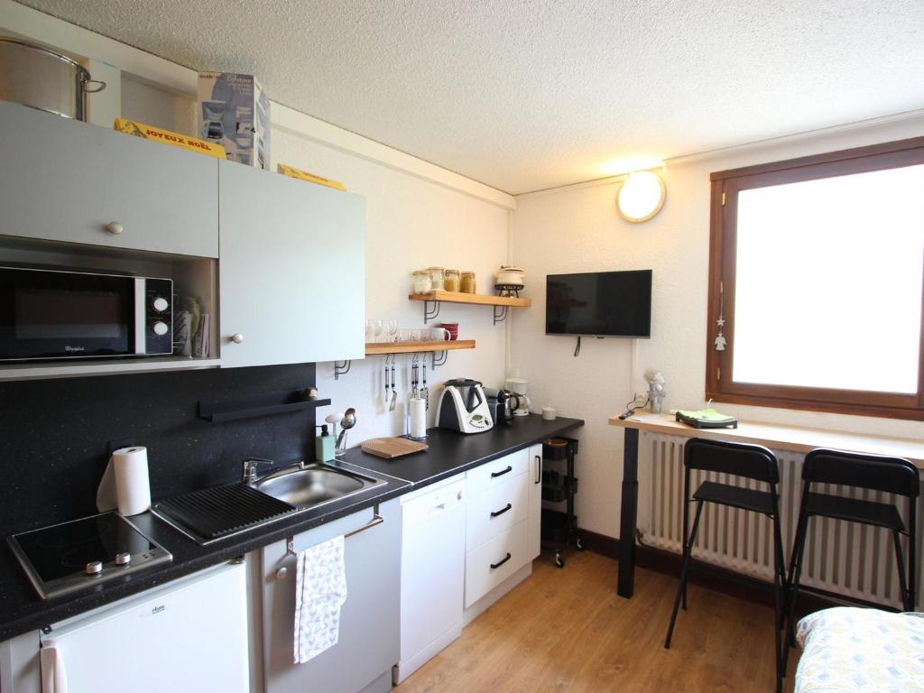 a kitchen with a sink and a counter top at Studio Chamrousse, 1 pièce, 3 personnes - FR-1-549-95 in Chamrousse