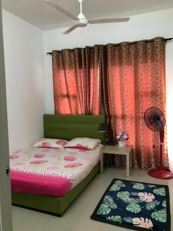a bedroom with a bed and a window with red curtains at Roomstay in Putrajaya (Female only/Queen bed) in Kampong Batu Sembilan