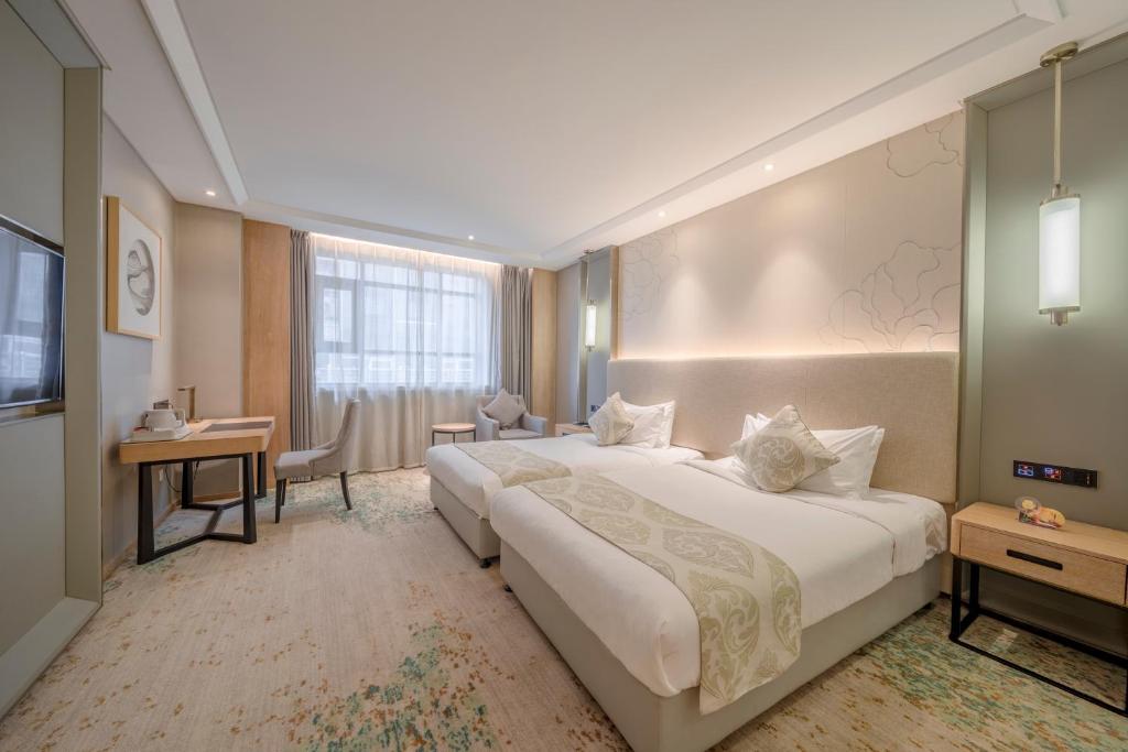 Voodi või voodid majutusasutuse Wuhan Hongguang Hotel toas